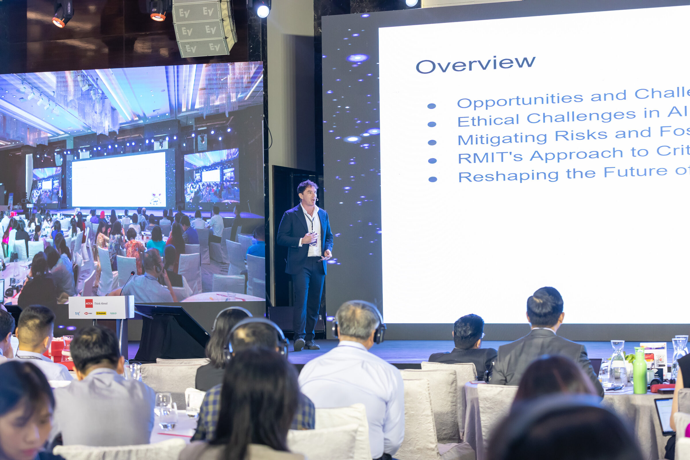 Nick McIntosh presenting on stage at the ACCA Asia Pacific Dialogue, Hanoi